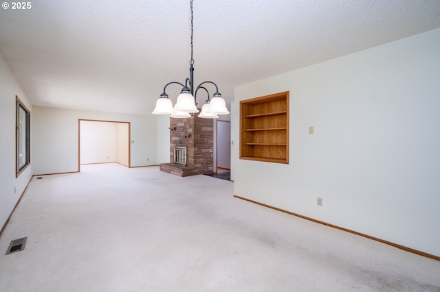 interior space featuring visible vents, a textured ceiling, a large fireplace, and carpet floors