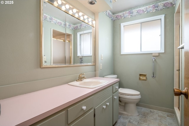 full bathroom with a shower with door, toilet, vanity, and baseboards