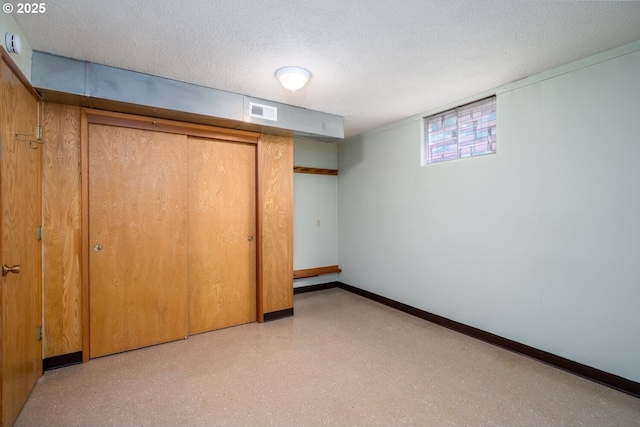 unfurnished bedroom featuring baseboards, visible vents, a closet, and a textured ceiling
