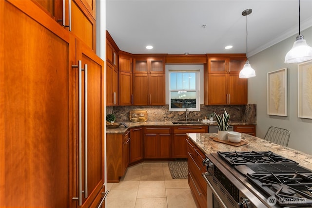 kitchen featuring paneled refrigerator, gas range, stone countertops, and a sink