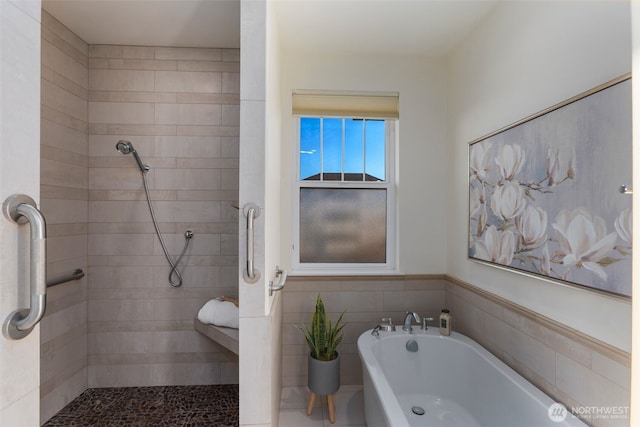 full bath with tiled shower, tile walls, and a bath