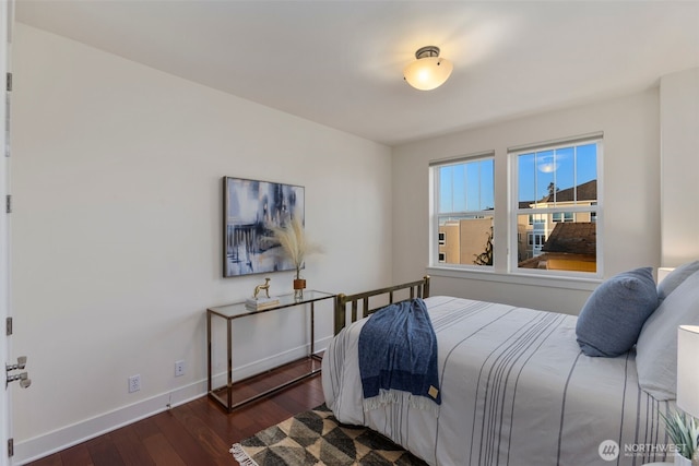 bedroom featuring baseboards and wood finished floors