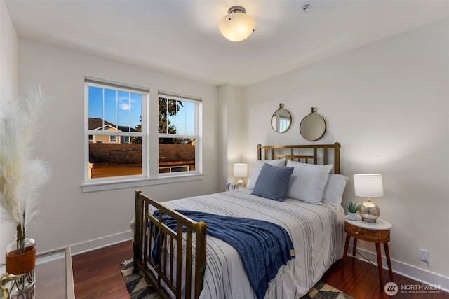 bedroom with wood finished floors and baseboards