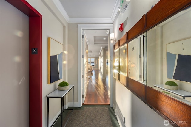 hall featuring crown molding and baseboards