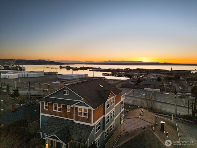 aerial view at dusk with a water view