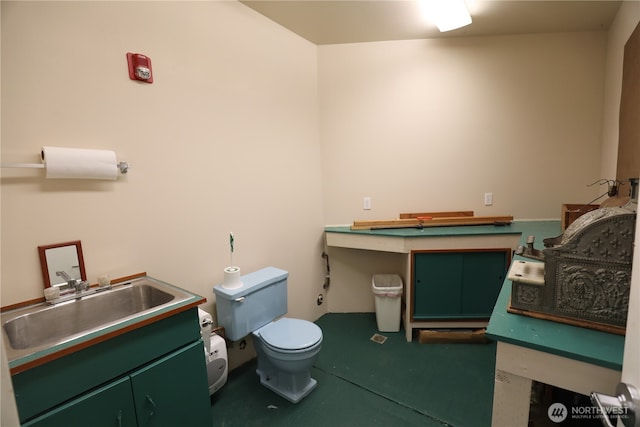 bathroom with toilet and a sink