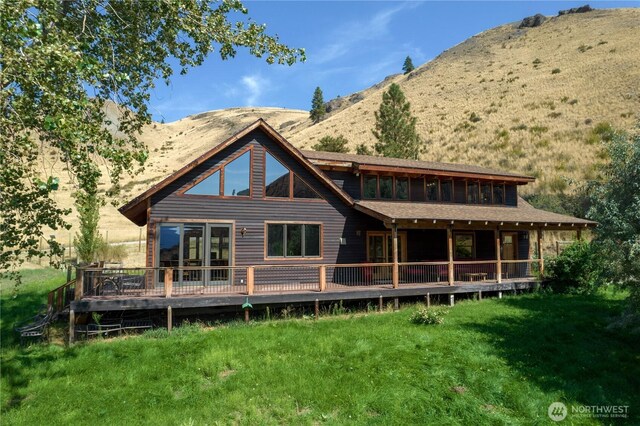 50 Sage Canyon Dr, Winthrop, WA 98862 - back of house with a deck with mountain view and a lawn