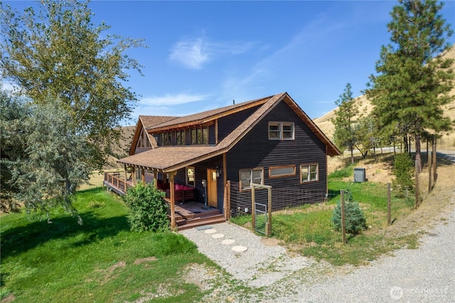 50 Sage Canyon Dr, Winthrop, WA 98862 - view of front facade featuring a deck, roof with shingles, and a front yard