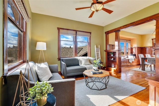 living area featuring a ceiling fan and wood finished floors