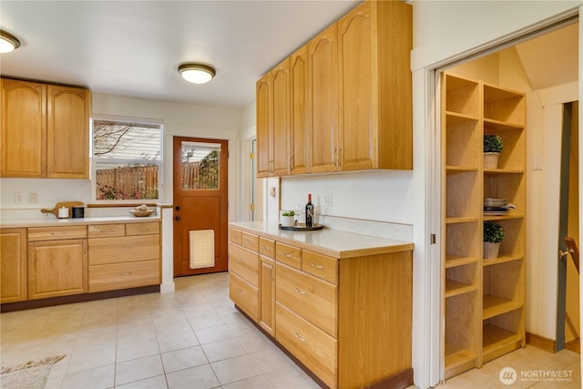 kitchen featuring light tile patterned flooring and light countertops