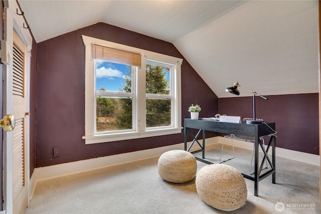 carpeted home office with lofted ceiling and baseboards