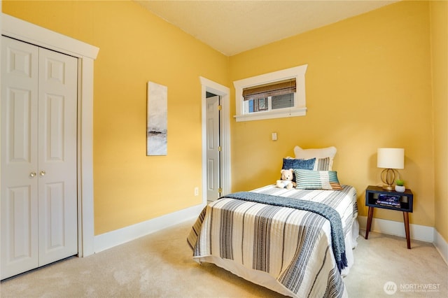 bedroom with baseboards, a closet, and carpet floors