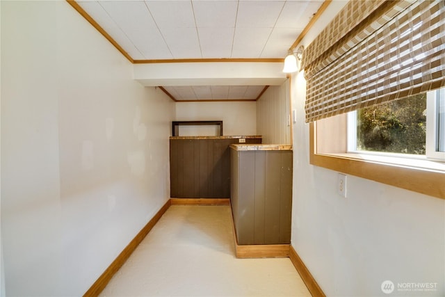 interior space with crown molding and baseboards