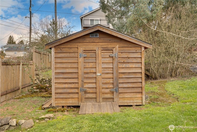 view of shed with fence