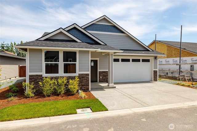 804 Parkland Loop, Sedro Woolley, WA 98284 - craftsman inspired home featuring concrete driveway, stone siding, an attached garage, and a shingled roof