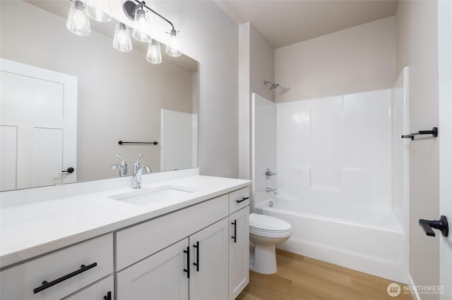 804 Parkland Loop, Sedro Woolley, WA 98284 - bathroom featuring vanity, toilet, wood finished floors, and shower / washtub combination