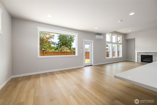 804 Parkland Loop, Sedro Woolley, WA 98284 - unfurnished living room with healthy amount of natural light, a wall mounted AC, light wood finished floors, and recessed lighting