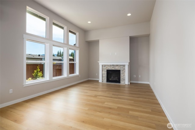 804 Parkland Loop, Sedro Woolley, WA 98284 - unfurnished living room with light wood finished floors, baseboards, recessed lighting, and a stone fireplace
