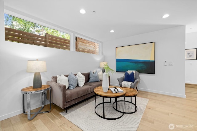 living area with recessed lighting, baseboards, and wood finished floors