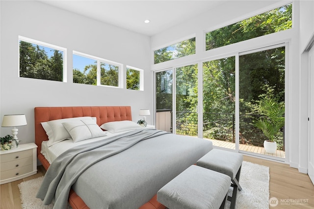 bedroom featuring recessed lighting, multiple windows, and wood finished floors