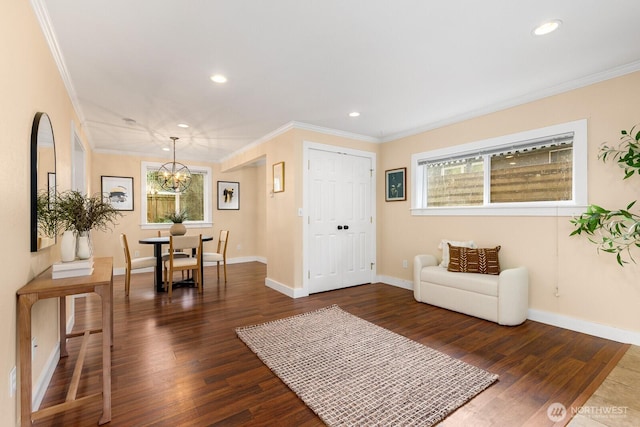 dining area featuring baseboards, dark wood finished floors, ornamental molding, a chandelier, and recessed lighting