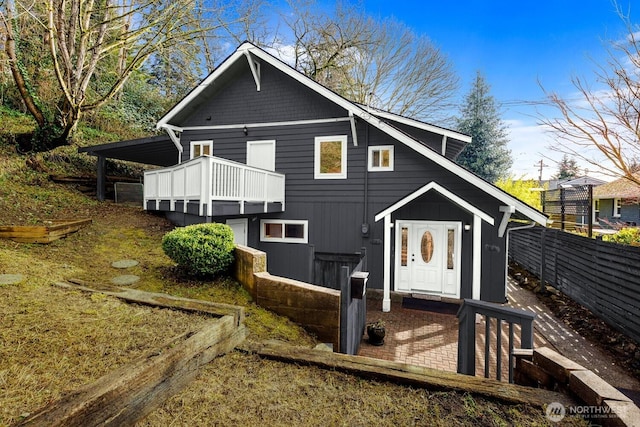 rear view of house with fence