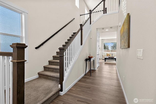 15132 Tyee Dr E, Bonney Lake, WA 98391 - stairway with a high ceiling, baseboards, and wood finished floors