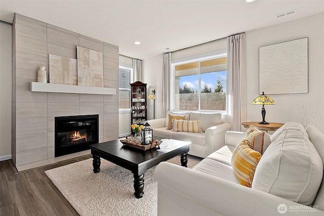 15132 Tyee Dr E, Bonney Lake, WA 98391 - living room with recessed lighting, visible vents, dark wood-type flooring, and a fireplace