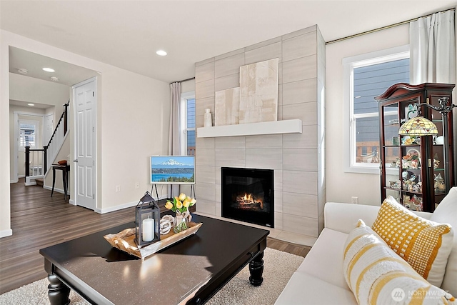 15132 Tyee Dr E, Bonney Lake, WA 98391 - living room featuring baseboards, stairway, recessed lighting, a tile fireplace, and wood finished floors