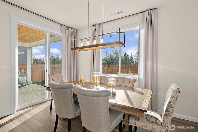 15132 Tyee Dr E, Bonney Lake, WA 98391 - dining area featuring visible vents, a healthy amount of sunlight, and wood finished floors