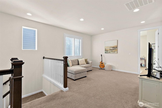15132 Tyee Dr E, Bonney Lake, WA 98391 - living area with carpet flooring, an upstairs landing, visible vents, and baseboards