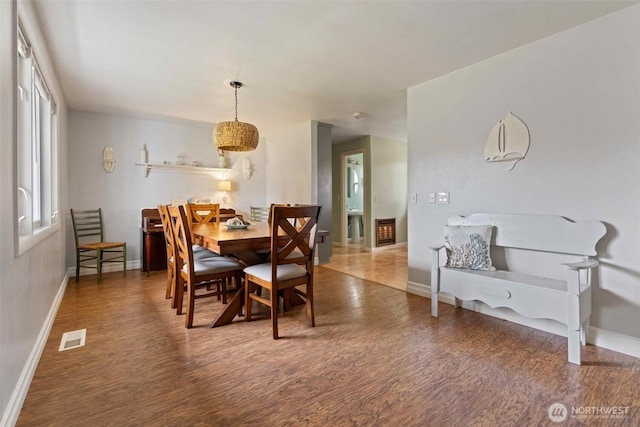 dining area with visible vents, baseboards, and wood finished floors