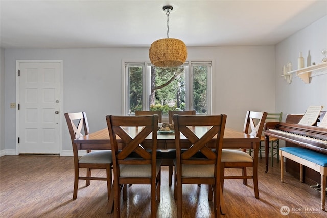 dining room with baseboards and wood finished floors