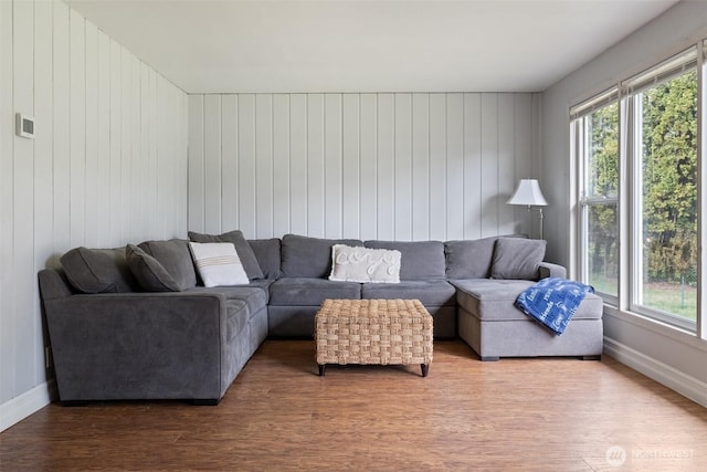 living area featuring baseboards and wood finished floors