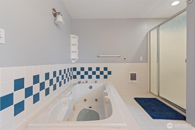 bathroom featuring a shower stall and a whirlpool tub