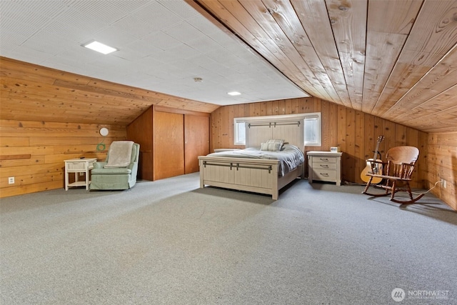 unfurnished bedroom featuring carpet floors, wooden walls, and vaulted ceiling