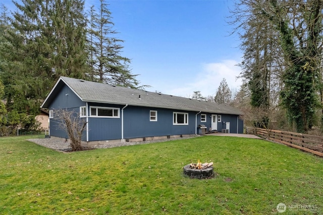 back of house with a patio area, fence, a lawn, and an outdoor fire pit