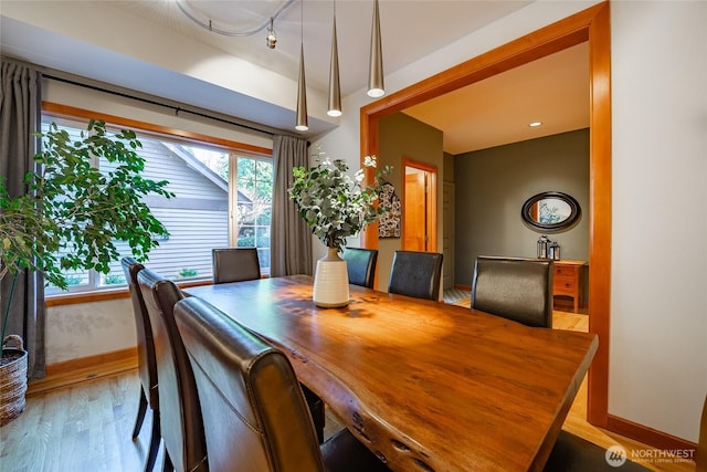 dining area with plenty of natural light, baseboards, and wood finished floors