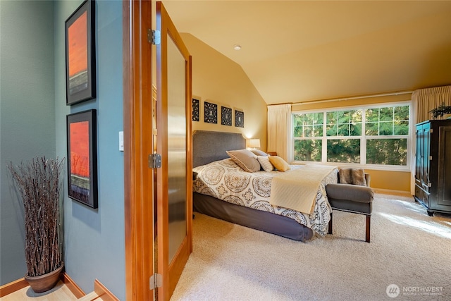 bedroom featuring baseboards, carpet floors, and vaulted ceiling