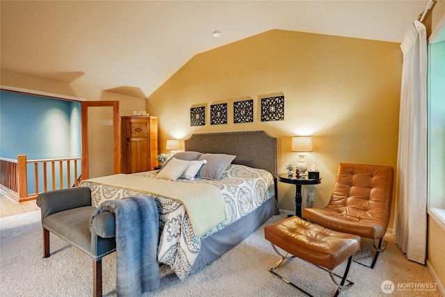 carpeted bedroom with vaulted ceiling and baseboards