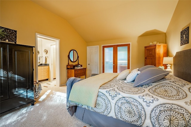 carpeted bedroom featuring vaulted ceiling, french doors, and connected bathroom