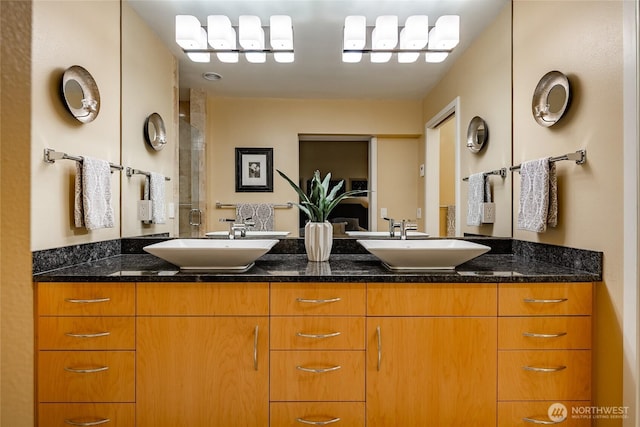 bathroom featuring double vanity and a sink