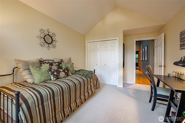 bedroom with a closet, high vaulted ceiling, and carpet