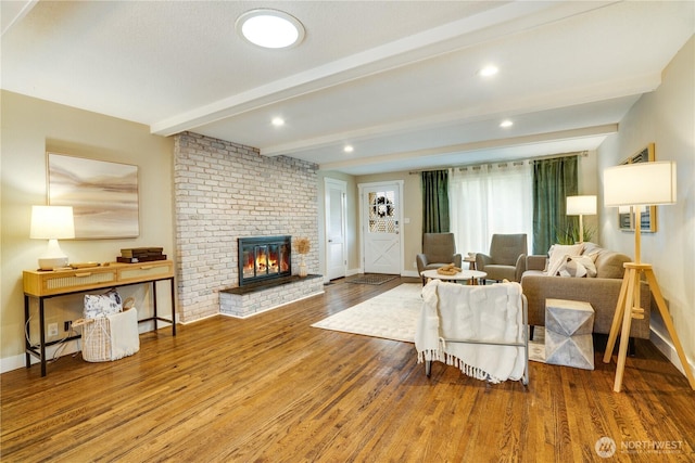 living room with baseboards, beam ceiling, recessed lighting, a fireplace, and wood finished floors