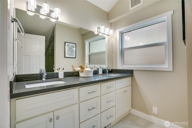 bathroom featuring visible vents, marble finish floor, baseboards, and a sink