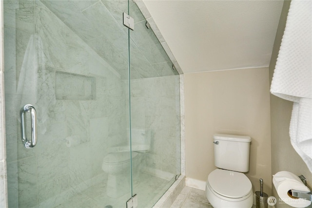 bathroom with lofted ceiling, toilet, and a shower stall