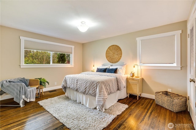 bedroom with visible vents, dark wood-type flooring, and baseboards