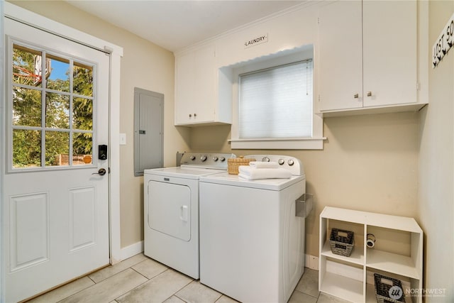 clothes washing area with electric panel, washing machine and dryer, cabinet space, light tile patterned floors, and baseboards