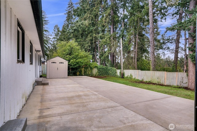 view of patio featuring an outbuilding, a storage shed, and a fenced backyard