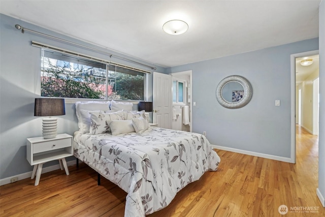 bedroom featuring light wood-type flooring and baseboards